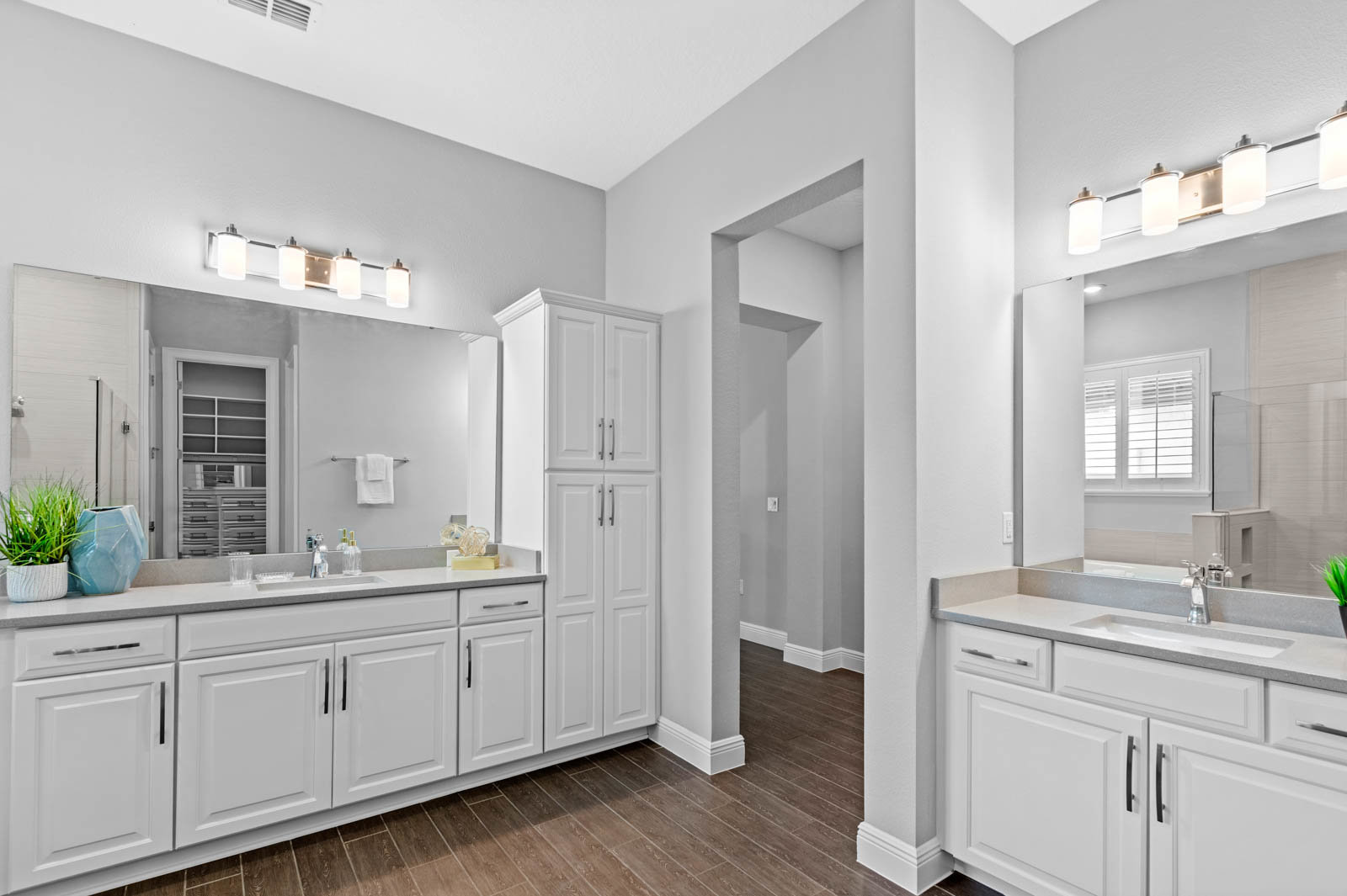 primary bathroom with white cabinets and dual sinks